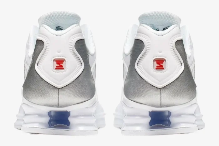 Rear view of Nike Shox TL sneakers in white and metallic silver showing the heel and Shox columns. - SKU AV3595-100