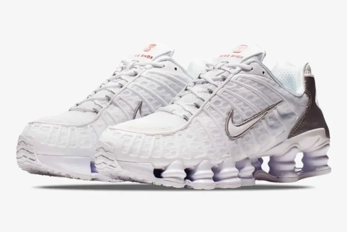 Nike Shox TL sneakers in white and metallic silver, shown from a three-quarter side perspective. - SKU AV3595-100
