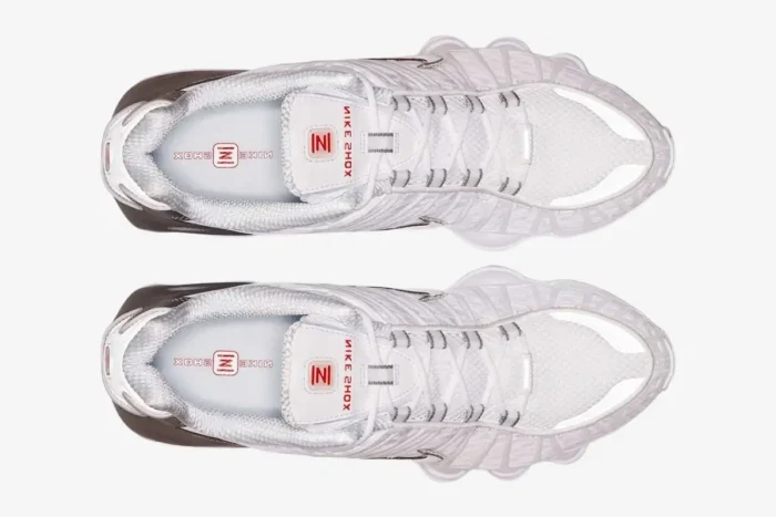 Top-down view of Nike Shox TL sneakers in white and metallic silver. - SKU AV3595-100