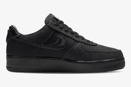 Side profile of the Nike Air Force 1 Low x Stussy Triple Black Hemp sneaker with an embroidered swoosh. - SKU CZ9084-001