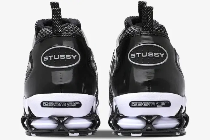 Rear view of Nike x Stussy Air Zoom Spiridon Cage 2 in Pure Platinum with black heel branding. - SKU CU1854-001