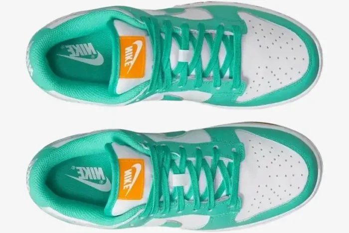 Top-down view of Nike Wmns Dunk Low 'Teal Zeal' sneakers with white leather, teal overlays, and orange tongue labels. - SKU DV2190-100