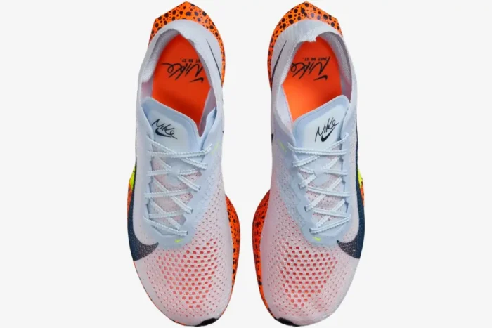 Top-down view of Nike ZoomX Vaporfly 3 running shoes in white with orange safari print and blue accents. - SKU FV2324-100