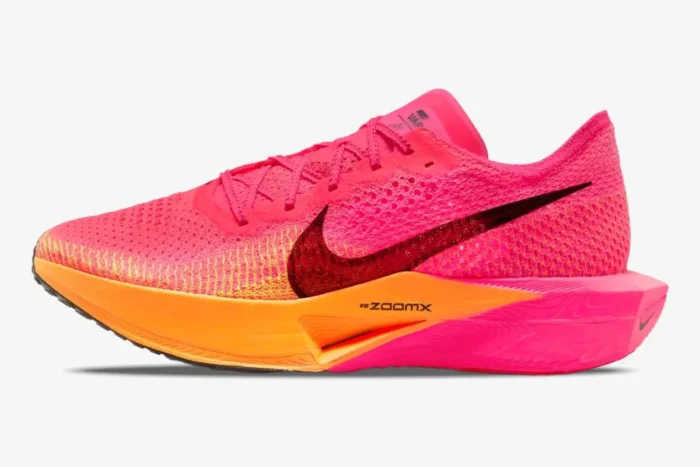Side profile of a Nike ZoomX Vaporfly 3 performance runner in vibrant pink and orange. - SKU DV4129-600