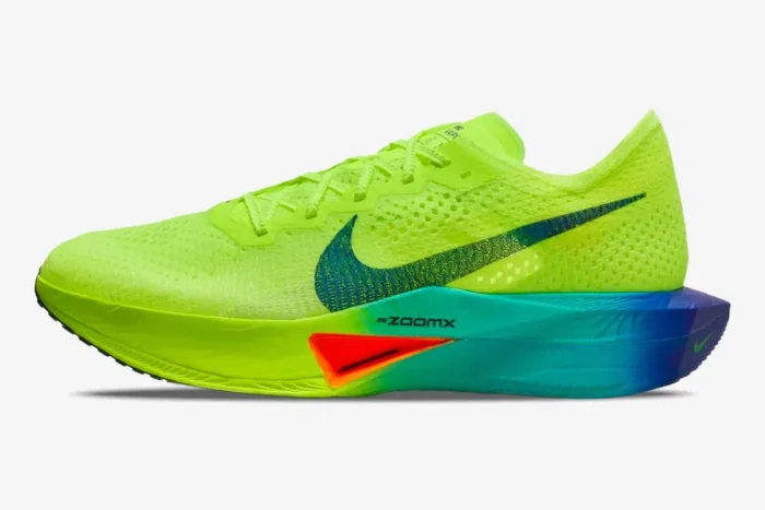 Side profile of a Nike ZoomX Vaporfly 3 marathon racing shoe in neon yellow with a blue and orange gradient midsole. - SKU DV4129-700