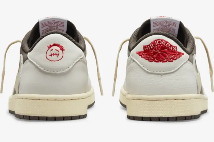 Rear view of Travis Scott x Air Jordan 1 Low Reverse Mocha sneakers showing red embroidered heel logos. - SKU DM7866-162