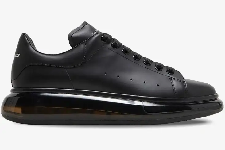 alexander-mcqueen-oversized-black-transparent-sole-604232-whx98-1000-707-962 Side profile of Alexander McQueen Oversized sneakers in black with a transparent sole. - SKU 604232-WHX98-1000