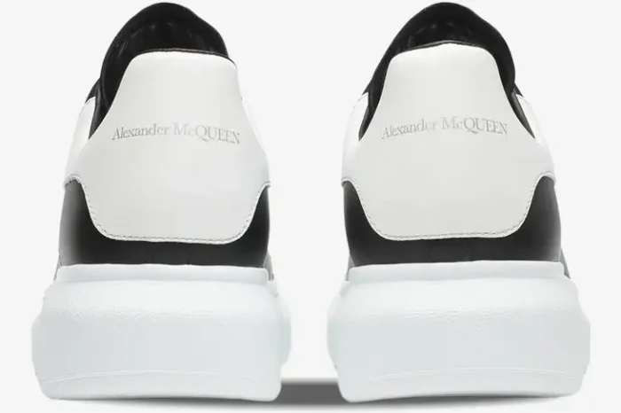 Rear view of Alexander McQueen Oversized Sneakers in black and white with silver logo on heel tabs. - SKU 553680-WHGP5-1070