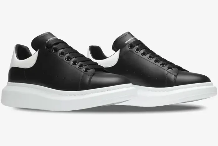 Alexander McQueen black and white oversized sneakers shown from a three-quarter side view. - SKU 553680-WHGP5-1070