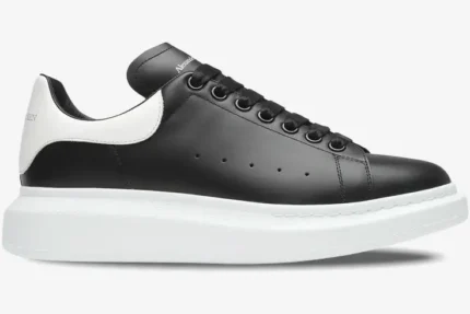 Side view of Alexander McQueen Oversized Sneaker in black leather with white heel and thick platform sole. - SKU 553680-WHGP5-1070