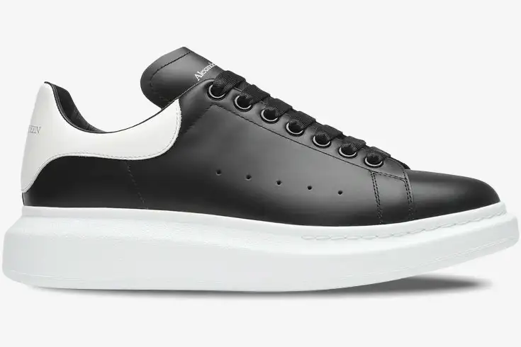 alexander-mcqueen-oversized-black-white-side-553680-whgp5-1070-924-242 Side view of Alexander McQueen Oversized Sneaker in black leather with white heel and thick platform sole. - SKU 553680-WHGP5-1070