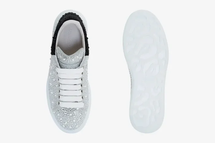 Top and sole view of Alexander McQueen crystal embellished oversized sneakers in white and black. - SKU 611697WHZ39