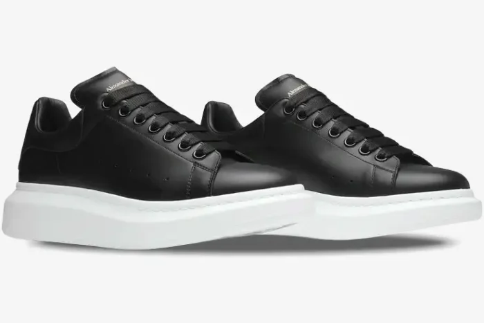 Side view of Alexander McQueen black leather oversized sneakers with thick white platform soles. - SKU 553680WHGP51000
