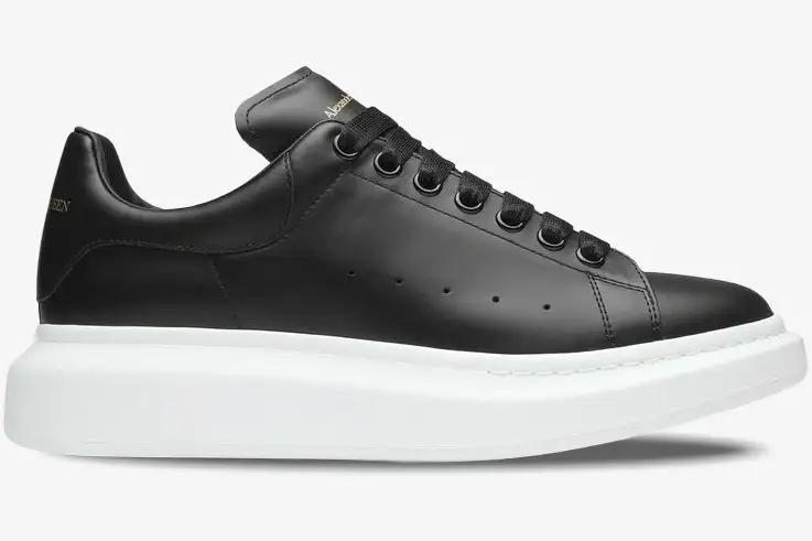 alexander-mcqueen-oversized-sneaker-black-side-553680whgp51000-323-881 Alexander McQueen Oversized Sneaker in black leather with a thick white sole, side profile view. - SKU 553680WHGP51000