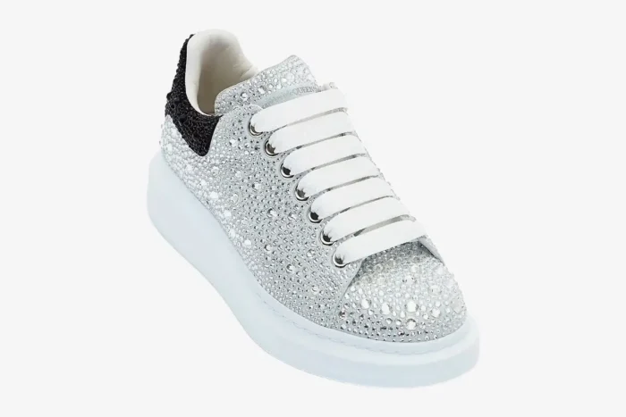Alexander McQueen white crystal-embellished oversized sneaker with black heel, three-quarter view. - SKU 611697WHZ39