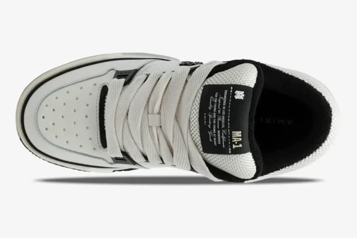 Top view of Amiri MA-1 Nappa luxury skate sneaker in white and black with star perforations and thick laces. - SKU AMFOSR1097-111