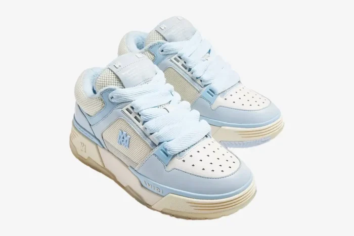 Amiri MA-1 luxury skate sneakers in white and light blue, shown from a three-quarter perspective. - SKU MFS001-111