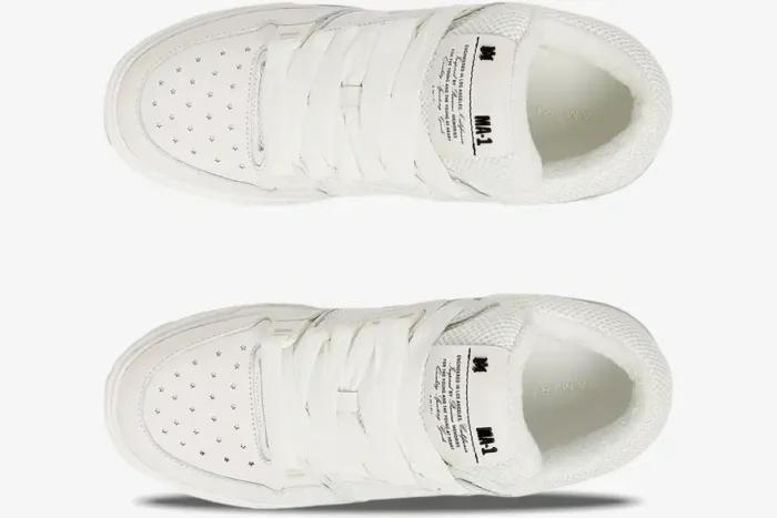 Top-down view of white Amiri MA-1 luxury skate sneakers featuring star-shaped toe perforations and thick laces. - SKU AMFOSR1097-100