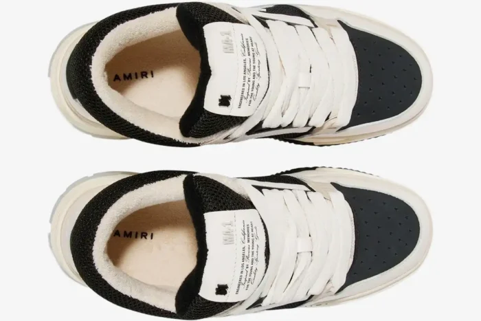 Top-down view of Amiri MA-1 sneakers in white and black with plush lining and branded tongue. - SKU PF23MFS010-111