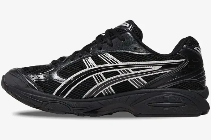 Side profile of Asics Gel-Kayano 14 sneakers in black with metallic silver accents. - SKU 1201A019-006