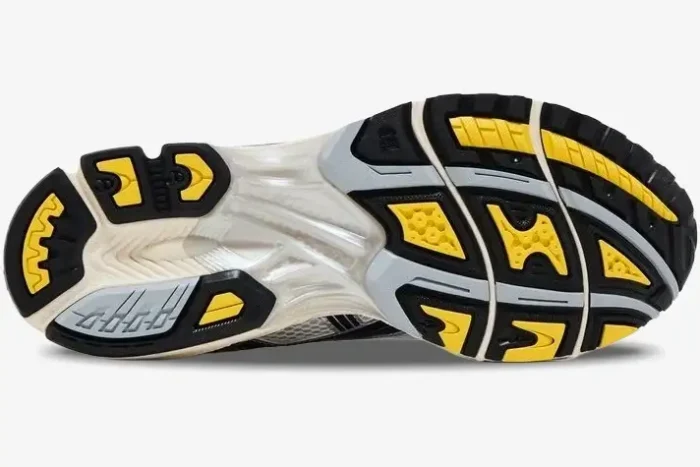 Bottom outsole view of ASICS Gel Kayano 14 x JJJJound sneaker in black, yellow, and white colors. - SKU 1203A961-100