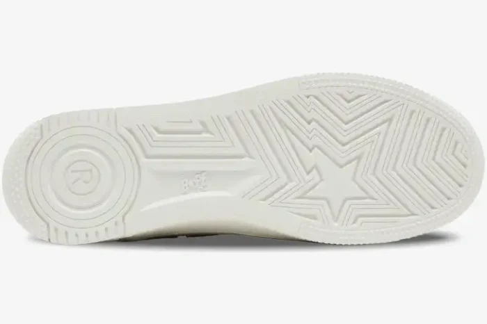 Bottom view of an off-white Bape Sta Low sneaker showing the rubber outsole with star pattern and logo branding. - SKU 1K70191335-GRN