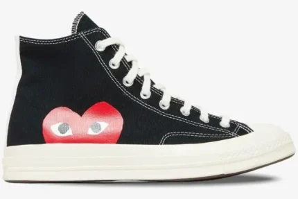 Side profile of a black Converse Chuck Taylor 70s high-top sneaker featuring the red CDG PLAY heart logo. - SKU 150204C