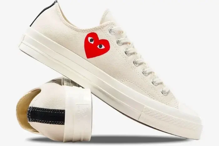 Side profile of white Converse Chuck Taylor 70s x CDG Play low-top sneakers with red heart logo. - SKU A08805C