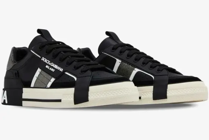 A pair of Dolce & Gabbana 2.Zero low top sneakers in black, white, and silver, shown from a three-quarter angle. - SKU CS1863A02238B979