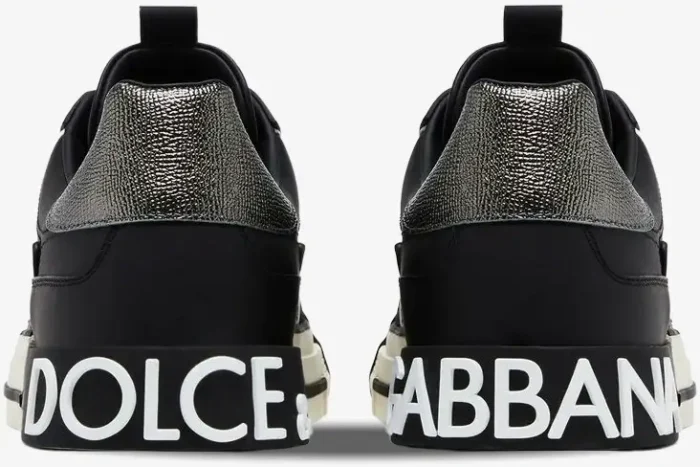 Rear view of Dolce & Gabbana 2.Zero low top sneakers in black and silver with white logo branding on the heels. - SKU CS1863A02238B979