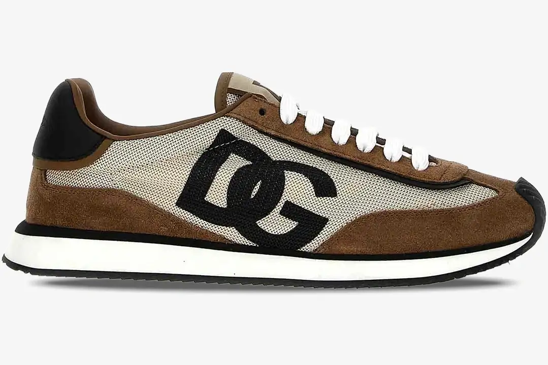 dolce-gabbana-cushion-sneaker-brown-side-view-cs2288a3d2489651-556-424 Side profile of a Dolce & Gabbana Cushion Sneaker in brown, beige, and white with a large black DG logo. - SKU CS2288A3D2489651