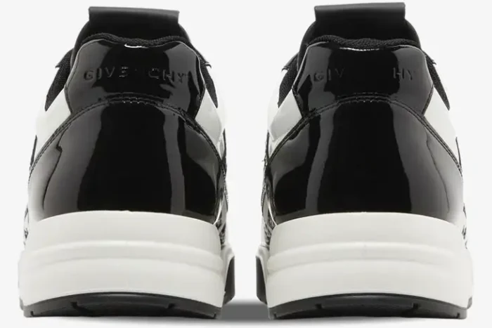 Rear view of Givenchy G4 sneakers in black and white patent leather with embossed logo on the heel. - SKU BH007WH1HJ-004