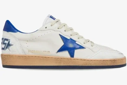 Side view of Golden Goose Ball Star sneakers in distressed white leather with a blue star and heel tab. - SKU GMF00117-F002198-10327