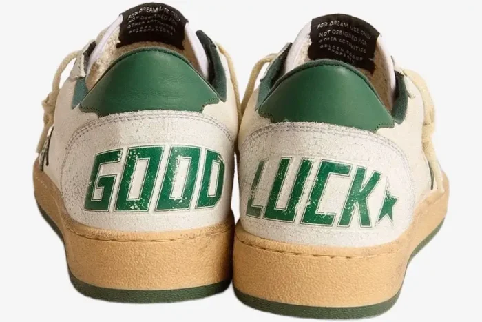Rear view of Golden Goose Ball Star sneakers in white, green, and tan featuring 'GOOD LUCK' text on the heels. - SKU GWF00117-F005821-10361