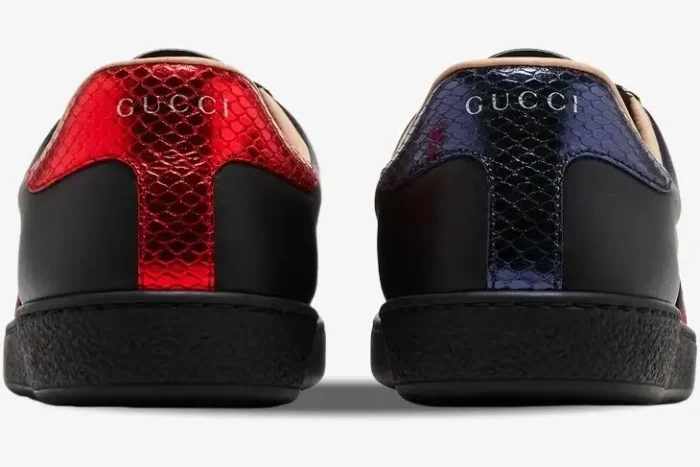 Back view of Gucci Ace Bee black leather sneakers featuring red and blue metallic snakeskin heel tabs. - SKU 42944602JP01284