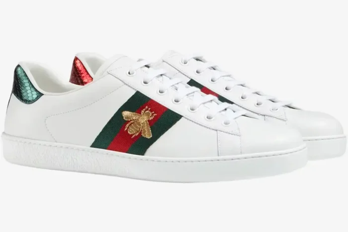 Side view of Gucci Ace white leather sneakers with embroidered gold bee and green-red web stripe. - SKU 42944602JP09064