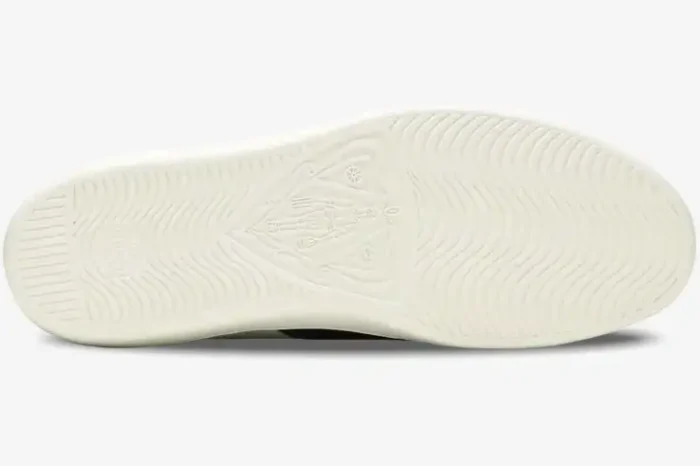 Bottom view of Gucci Ace Bee white leather sneakers showing the white rubber sole with wavy tread and crest logo. - SKU 42944602JP09064