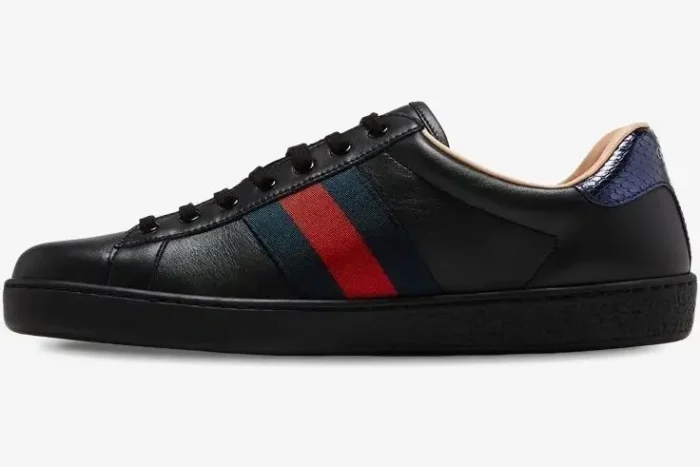 Side view of a Gucci Ace black leather sneaker with red and green web stripe and blue snakeskin heel tab. - SKU 42944602JP01284
