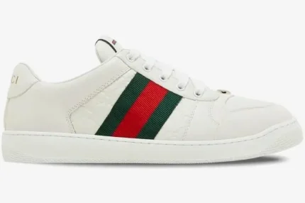 Side view of white Gucci Ace Embossed GG Leather Sneakers with green and red web stripe. - SKU 798785AADU09094