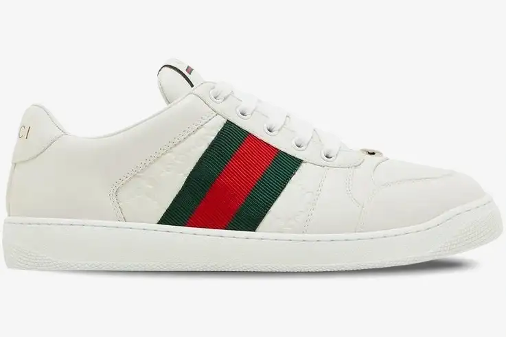 gucci-ace-embossed-gg-leather-sneaker-side-798785aadu09094-888-874 Side view of white Gucci Ace Embossed GG Leather Sneakers with green and red web stripe. - SKU 798785AADU09094