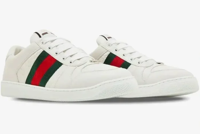 White Gucci Ace embossed GG leather sneakers with green and red web stripe, three-quarter view. - SKU 798785AADU09094