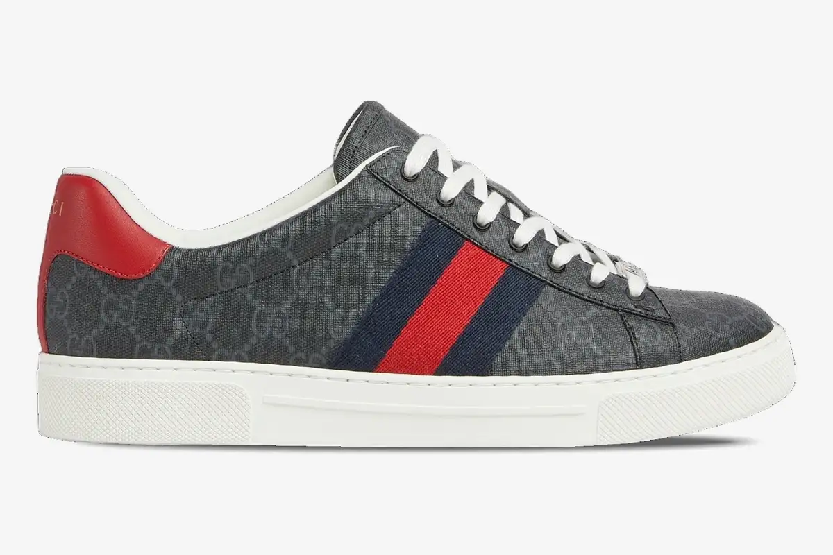 gucci-ace-gg-supreme-canvas-sneaker-side-view-760775facmz1065-436-247 Side view of Gucci Ace GG Supreme sneakers in grey canvas with blue and red web stripes. - SKU 760775FACMZ1065