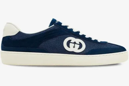 Side profile of a Gucci G74 Interlocking G blue suede sneaker with white sole and laces. - SKU 791742AADM04141