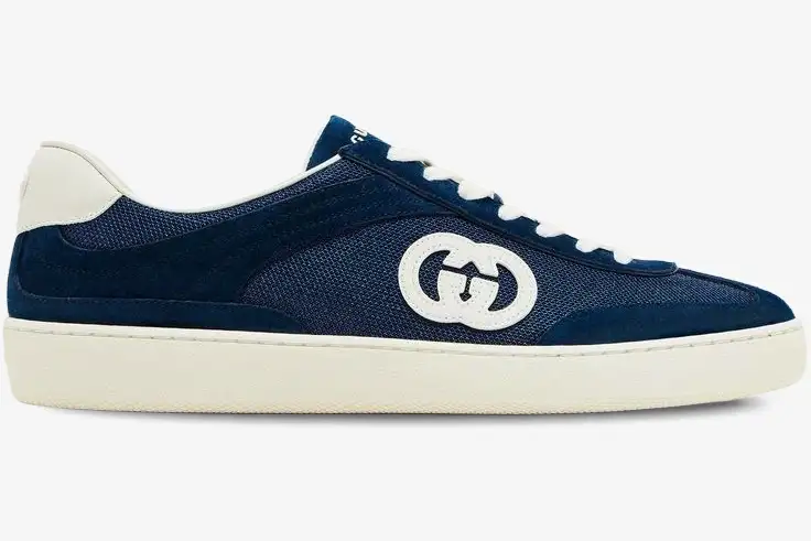 gucci-g74-interlocking-g-blue-suede-side-view-791742aadm04141-639-708 Side profile of a Gucci G74 Interlocking G blue suede sneaker with white sole and laces. - SKU 791742AADM04141