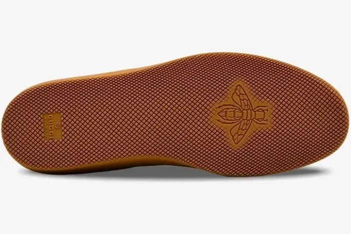 Bottom view of the Gucci G75 gum rubber sole featuring a textured pattern and embossed bee logo. - SKU 791742AAEGA2242