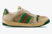 Side profile of Gucci GG Screener Distressed sneakers in beige GG canvas with green and orange web stripe. - SKU 5465519Y9209666