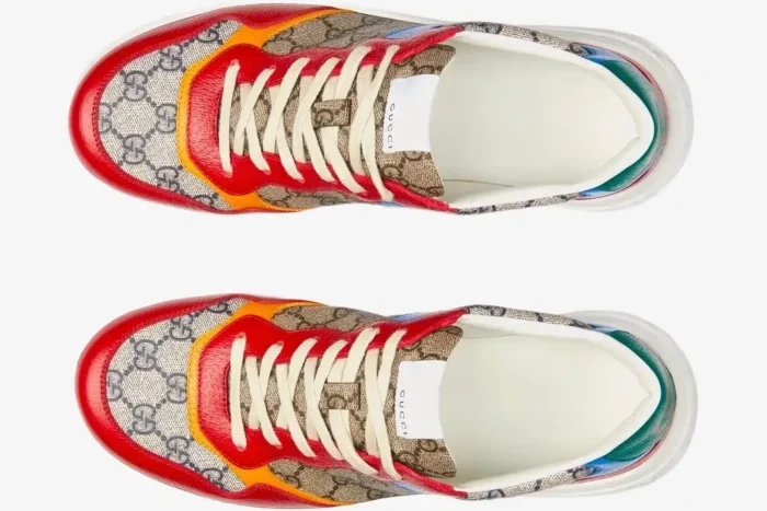 Top-down view of Gucci GG Supreme low top sneakers in beige and blue with red and orange details. - SKU 726828FABAV4050