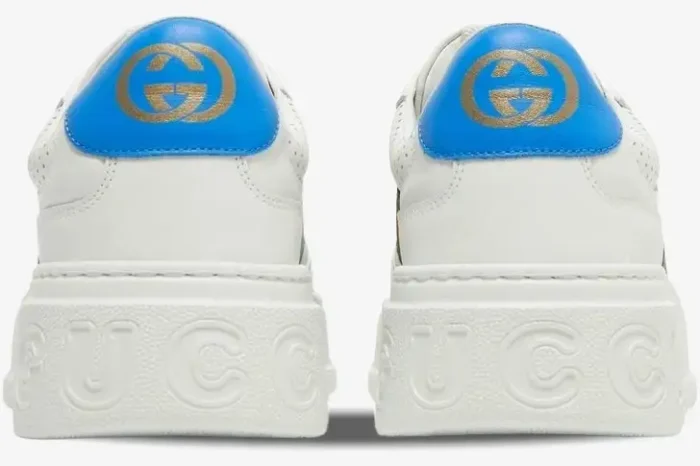 Rear view of white Gucci Mac80 Chunky GG Web Sneakers with blue heel tabs and embossed logo on the sole. - SKU 669698UPG109060