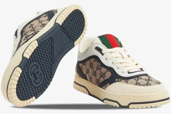 Gucci Re-Web Sneaker in beige GG canvas, ivory, and blue, showing the side profile and patterned sole. - SKU 787476AADHW9552