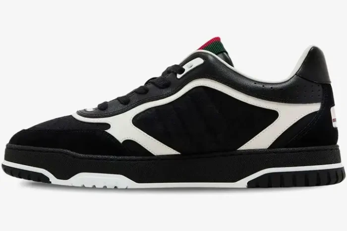 Side profile of a Gucci Re-Web sneaker in black GG canvas and leather with white trim. - SKU 787476AADHW1077